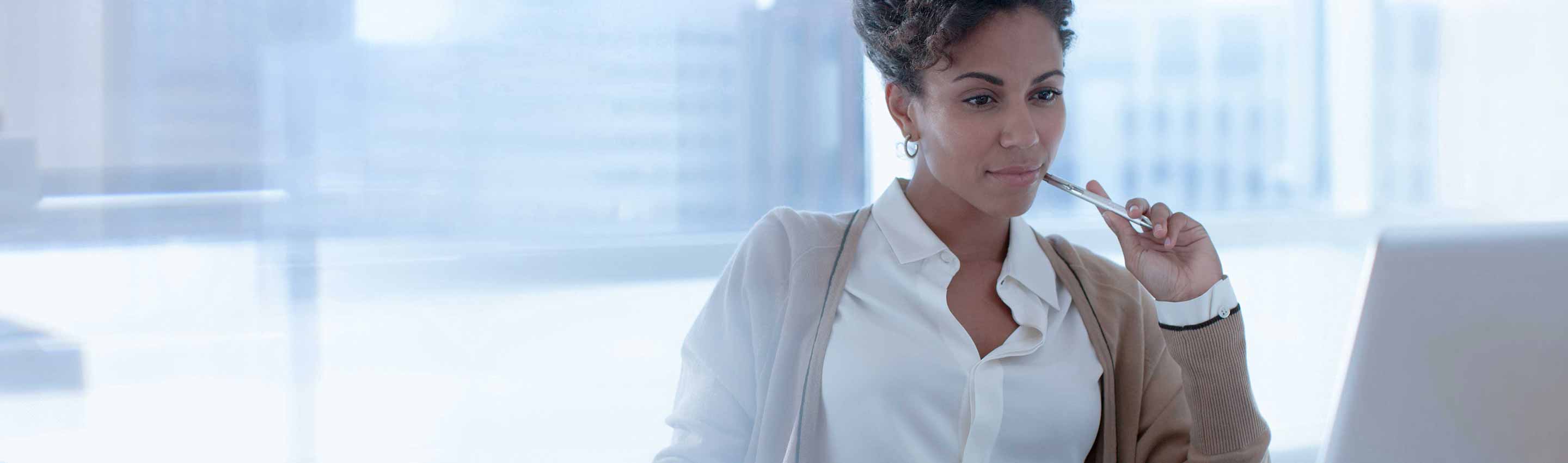 Business Person examining procurement analytics and laptop